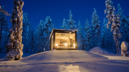 Magical winter night in Akaslompolo with a cozy cabin surrounded by snowy trees