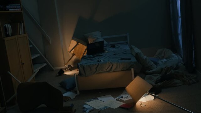 Stab long lowkey shot of messy bedroom with broken flickering lamp on floor, unmade bed and scattered papers at night