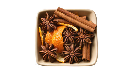 Isolated fragrant star anise, cinnamon sticks, and orange peel in a ceramic bowl