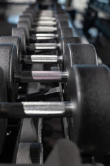 Naklejka premium Gym equipment weights and various exercise tools, creating environment for effective workouts and strength training. Modern and clean gym interior with sport and fitness equipment, fitness center inte