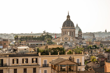 Rome rooftops and church dome in warm morning light