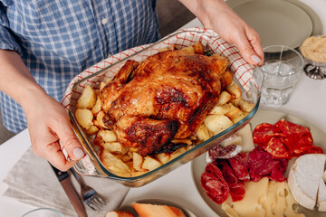 Roast Chicken or a turkey  With Potatoes Served At A Cozy Family Dinner Table With Red Wine