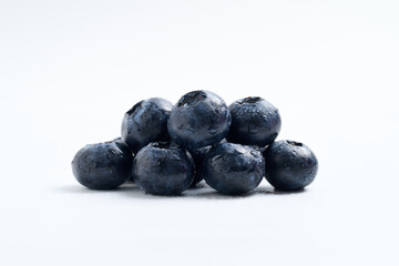 Close-up of Fresh Blueberries on White Background, Ripe Berries with Water Drops