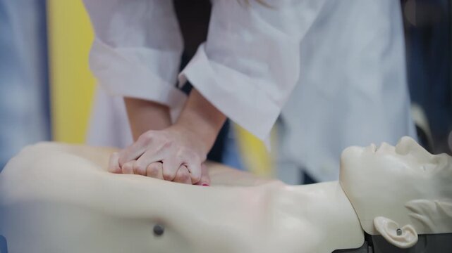 Medical student practicing cpr on a mannequin