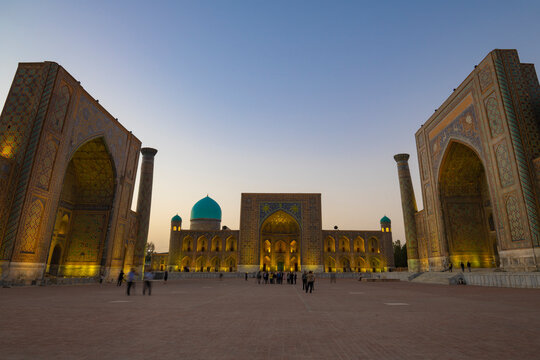 The ancient Registan Square illuminated in the evening twilight. The historical center of Samarkand