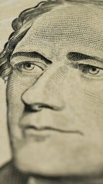 Detailed image of historical figure Alexander Hamilton. Protective lines, intricate patterns, microtext at ten Dollars. Security measures in high denomination banknotes. Paper fibers on USA money