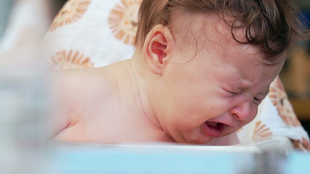 Baby wailing in high chair, overwhelmed expression, deep emotional reaction, moment of intense crying, early childhood discomfort, strong feelings of frustration