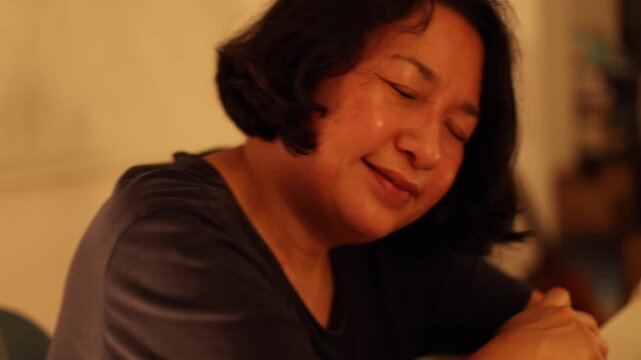 Drunk Asian woman feel relax with music (no sound)