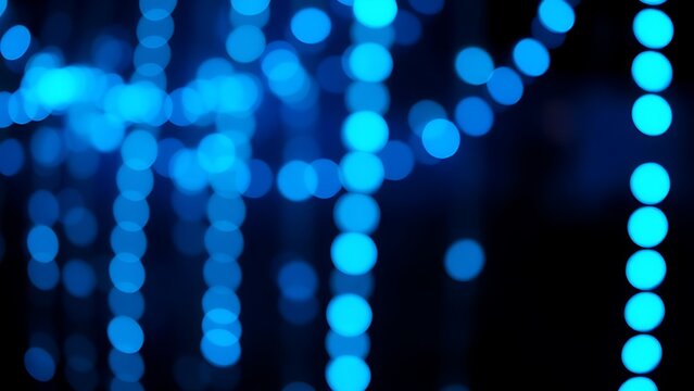 Glowing blue LED lights forming an abstract pattern against a dark, bokeh-filled background.