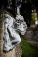 Fototapeta premium Old European Graveyard with angel statue on tombstone, crosses and religious symbols, spooky atmosphere, Pere la Chaise Cemetery, Paris France