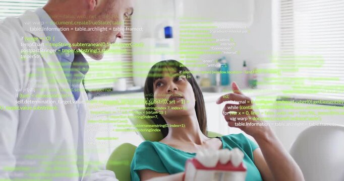 Dentist picking up dental model, rotating model while patient pointing for treatment planning