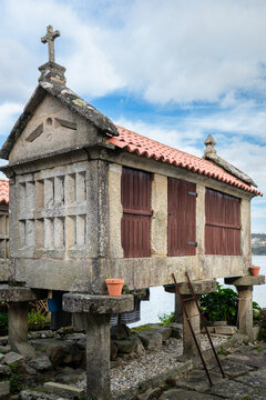 Traditional stone horreo standing on pillars protecting stored grain from rodents and humidity, a cultural and architectural heritage overlooking the Ria de Pontevedra