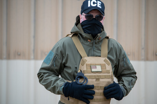 A U.S. Immigration and Customs Enforcement agent is conducting surveillance.
