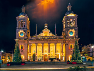 Christmas lights illuminate the Minor Basilica of Christ the King at night in Paola, Malta