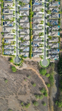 Aerial view of neatly organized residential neighborhood juxtaposed against the arid landscape, a study in planned community, Honolulu, Hawaii, United States.