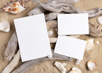 Blank cards mockup on sand with seashells and driftwood, beach wedding and summer event template © katrinshine