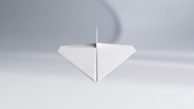 ?Minimalist white paper plane flying through a tunnel in slow motion
