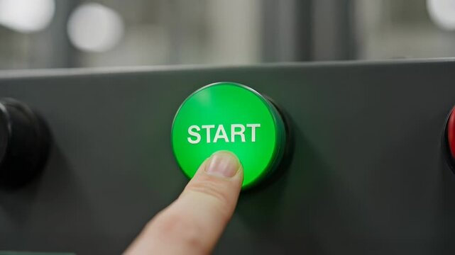 ?Pressing a start button to activate machinery in closeup sequence