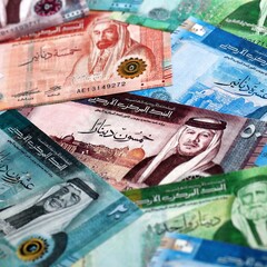 Jordanian dinar money bills pile on table. Jordan banknotes of JOD currency close up.