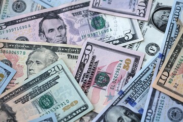 Big pile of US dollar bills in various nominations. United States money banknotes