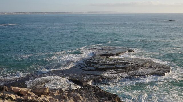 4k 60p footage of the rocky coastline near Waenhuiskrans Cave, Arniston. Rock ledges meet ocean waves in Overberg seascape, Western Cape, South Africa. Ideal for nature, travel, and adventure visuals.