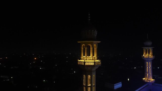 Historic Mosque with Ramadan Lights
Beautiful Night Aerial View - Drone orbiting a tall minaret of an illuminated mosque - 4K video