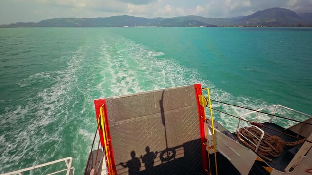 Two Human Shadows On Ferry Ramp With Flag Waving In Wind Above Turquoise Sea Showing Travel Motion And Maritime Journey