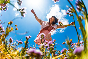 Summer lifestyle portrait of a beautiful young brunette in a summer pink dress. Romantic mood.