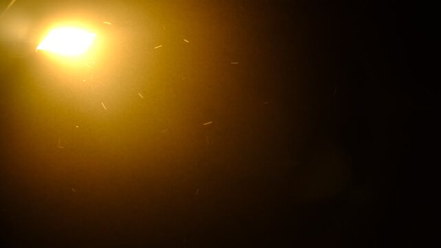 Blurred light bulb in the night. Dusk surreal scene. Mystery fog and spotlight. Lens Bokeh. Flare lights