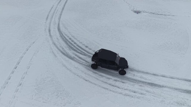 Drone tracking UTV on frozen pond