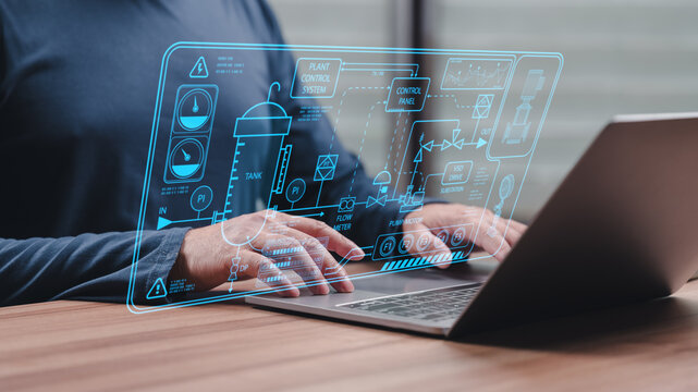 Engineer hands operating laptop keyboard display glowing blue industrial interface plant control system digital dashboard futuristic technology automation manufacturing factory process management
