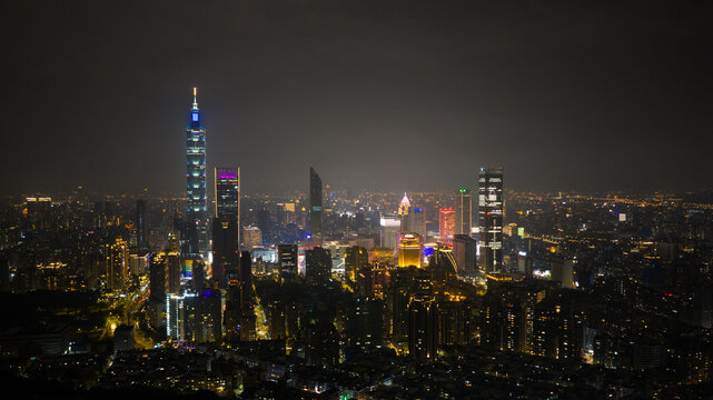 Aerial view of the Taipei 101 skyscraper piercing the night sky, surrounded by a sea of glittering city lights, Taipei City, Taiwan.