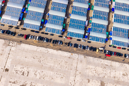 Overhead view of the marywilska 44 shopping center in warsaw, showing rooftops, parked cars, and market stalls, Warsaw, Masovian Voivodeship, Poland.