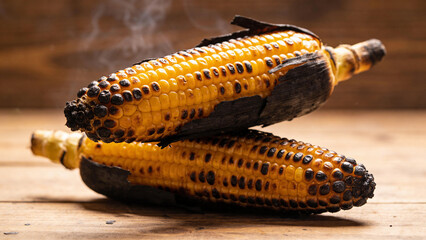 Fototapeta premium Corn on wooden surface shows texture and detail in food and agriculture settings