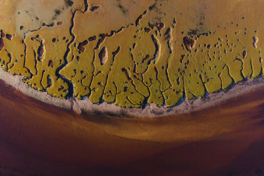 Aerial view of the rugged marshland where earthy hues meet the deep brown river, Achnahaird, Ross and Cromarty, United Kingdom.