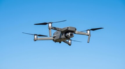 Fototapeta premium Drone Flying in Blue Sky with Propellers and Camera Visible