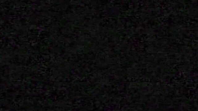 A dark, textured background with no discernible features or objects, suitable for use as a backdrop or overlay.