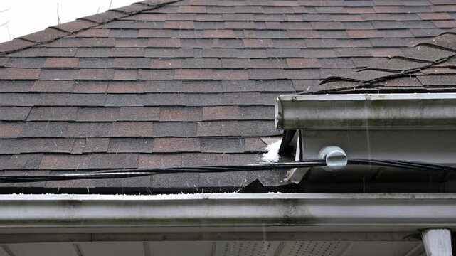 Ice pellets falling on roof. Detail of asphalt shingles. Winter in Toronto, Canada. 4K.