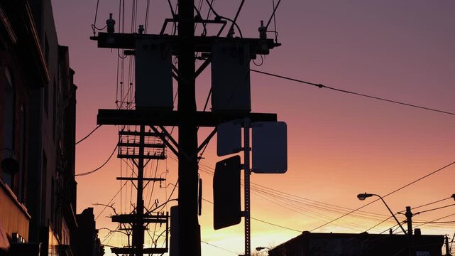City silhouette of transformers and phone wires with sunset. Toronto. 4K.