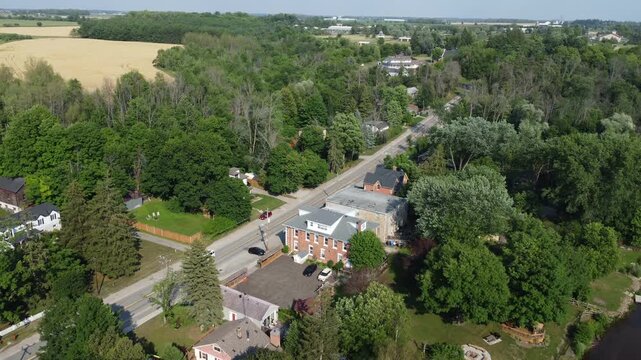Aerial view of the Cheltenham area, a community within the town of Caledon, Ontario, Canada. Shot by a drone on a hazy summer afternoon along Creditview Road.