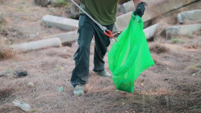 The actions of a dedicated Asian man, a true environmentalist, as he meticulously collects trash in a contaminated environment, demonstrate a commitment to cleanup and environmental awareness.