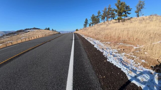Immersive POV from winter biking on the Centennial Road along Horsetooth Reservoir in Colorado foothills near Fort Collins