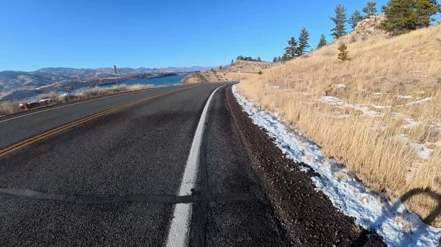 Immersive POV from winter biking on the Centennial Road along Horsetooth Reservoir in Colorado foothills near Fort Collins