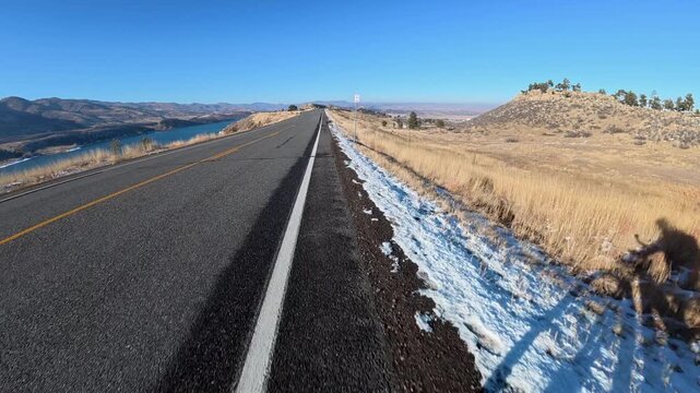 Immersive POV from winter biking on the Centennial Road along Horsetooth Reservoir in Colorado foothills near Fort Collins