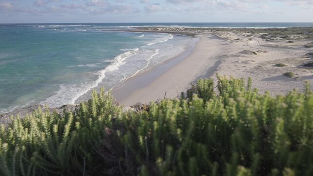 4k 60p footage of dramatic coastal view to Struis Point (Struispunt) and Saxon Reef from rugged sea cliffs near Waenhuiskrans Cave, Arniston. Turquoise Overberg waters, Western Cape, South Africa.