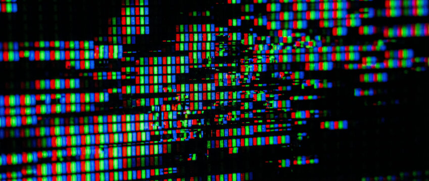 Macro view shows vibrant LCD screen pixels displaying color with cinematic lighting