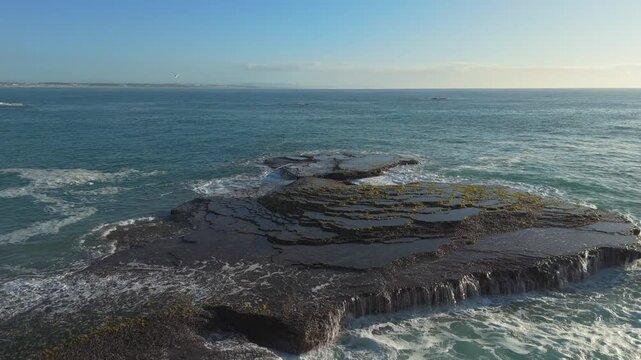 4k 60p footage of the rocky coastline near Waenhuiskrans Cave, Arniston. Rock ledges meet ocean waves in Overberg seascape, Western Cape, South Africa. Ideal for nature, travel, and adventure visuals.