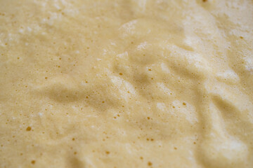 Pale almond flour cake batter with whisk marks macro close-up