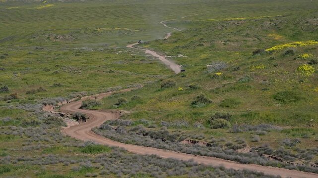 Vehicles travelling on dirt trail in Carrizo Plains.