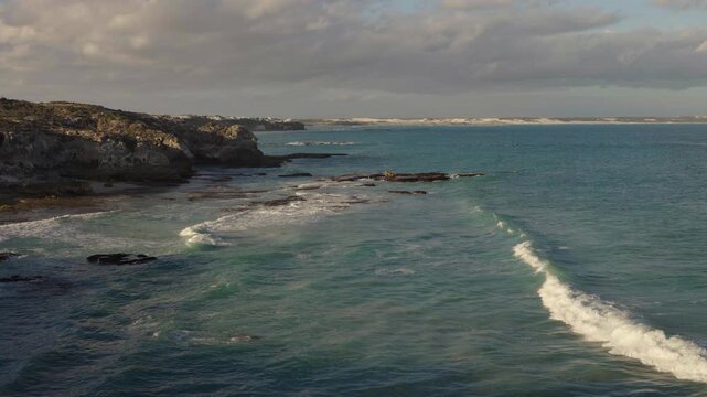 4k 60p footage of stunning turquoise waters along Arniston&rsquo;s beautiful Overberg coastline with sand dunes visible in the background. Western Cape, South Africa. Iconic, remote coastal serenity.